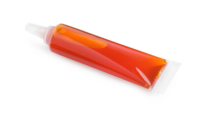 Tube with orange food coloring on white background