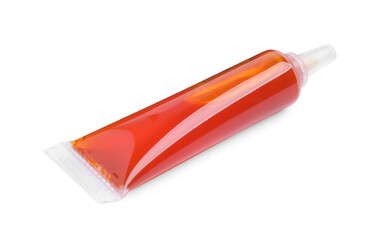 Tube with orange food coloring on white background