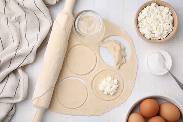 Process of making dumplings (varenyky) with cottage cheese. Raw dough and other ingredients on...