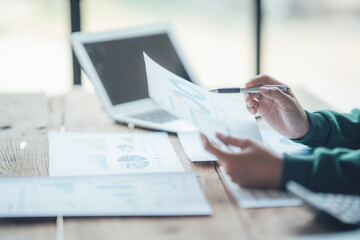 Financial Businesswomen analyze the graph of the company's performance to create profits and growth, Market research reports and income statistics, Financial and Accounting concept.