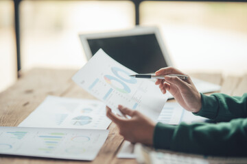 Financial Businesswomen analyze the graph of the company's performance to create profits and growth, Market research reports and income statistics, Financial and Accounting concept.