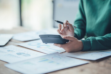 Financial Businesswomen analyze the graph of the company's performance to create profits and growth, Market research reports and income statistics, Financial and Accounting concept.