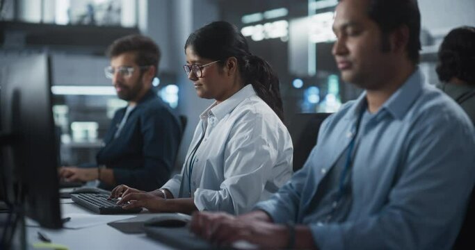 Portrait of a Team of Talented Young Indian Professionals Working in a Technological Research and Development Agency. Computer Screens with Software Code and Technical Neural Network Diagrams