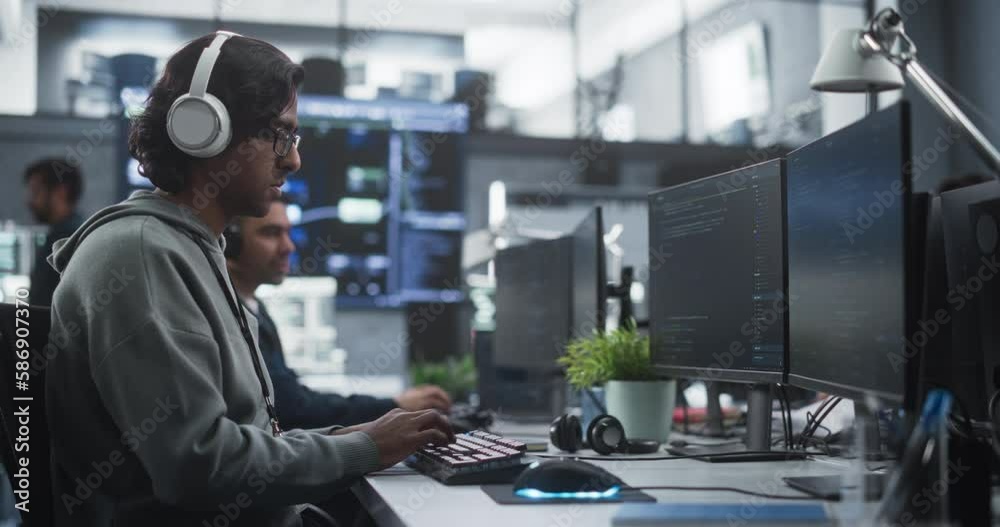 Fototapete System Administrator Working in a Research E-Business Facility on a Desktop Computer. Focused Software Developer in Casual Clothes Wearing Headphones and Updating Server System Database