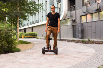 Man riding hoverboard, city. Guy on blue gyroboard