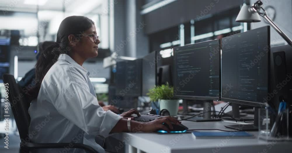 Poster Young Female Artificial Intelligence Engineer Working on Computer in a Technological Office. Young Indian Specialist Writing Software Code for an Innovative Big Data Blockchain Project