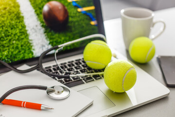 laptop with stethoscope and tennis