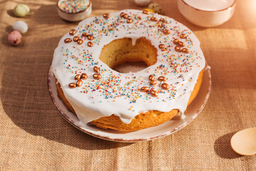 Round Easter cupcake decorative with white protein cream on a wooden table in the kitchen. Top view