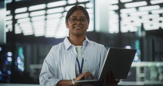 Portrait of a Young Attractive Empowered Indian Woman Looking at Camera and Charmingly Smiling. Specialist at Work, Information Technology Manager, Software Engineering Professional