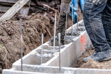 concreting from the pipe of the foundation of the building from the lost formwork