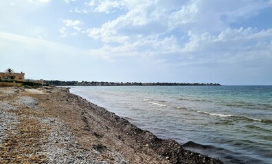 evocative image of a sandy beach in Sicily in summer under a beautiful blue sky 
