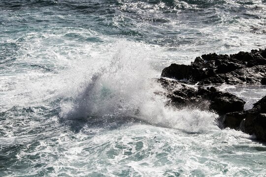 evocative image of a rough sea hitting the rocks in Sicily
