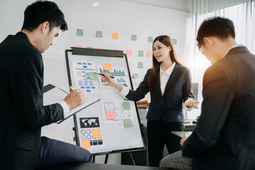 Group of Young Asian business team creative businesspeople coworker in office. Meeting Presentation for analysis graph company financial. People Work in Business Office.