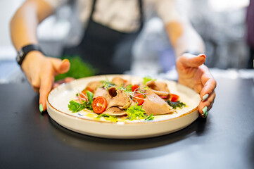 Chef cooking Beef tongue salad with fresh vegetables on restaurant kitchen