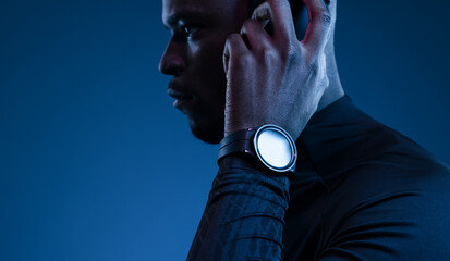 Serious black man in headphones and smart watch