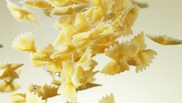 Super slow motion of flying Italian pasta fettuccine into water. Filmed on high speed cinema camera, 1000 fps. Speed ramp effect.