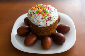 easter cake and red eggs on rustic wooden table. Top view.
