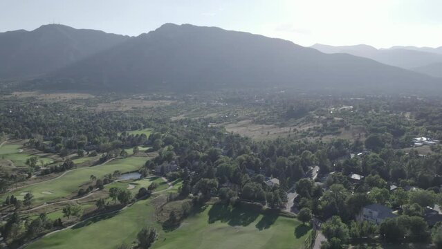 Colorado Country Club Golf Course, with Cheyenne Mountain in the background in Colorado Springs, Colorado. Aerial 4K drone video in the Rocky Mountains. 