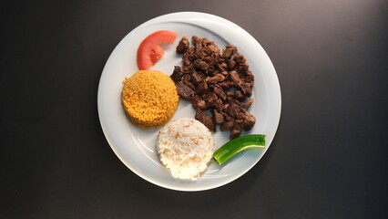 diced roasted meat served on a plate in the background