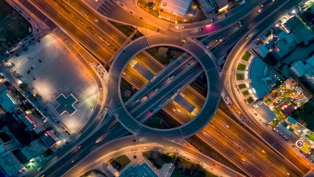 Aerial time lapse view of multilevel junction ring road during night time as seen in Attiki Odos motorway interchange with Kifisias Avenue in Marousi Attica, Athens, Greece
