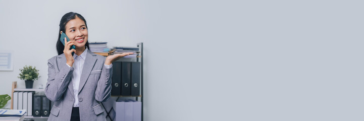 Using mobile smartphone, Young confident asia people entrepreneur ceo female business woman broker in suit office worker, help clients. © NanSan