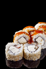 sushi roll with tofu cream cheese eel unagi on a black mirror background