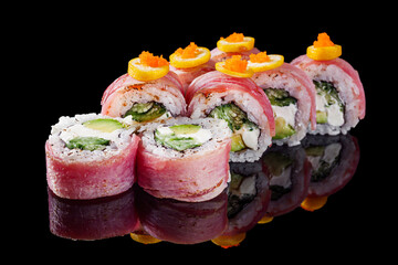 sushi roll with cream cheese, grilled tuna, cucumbers, avocado on a black mirror background