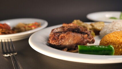 Beef breast ribs served with rice and appetizers on a serving plate
