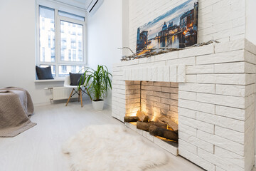 Modern interior house with bright living room, fire in new fireplace, wall on background