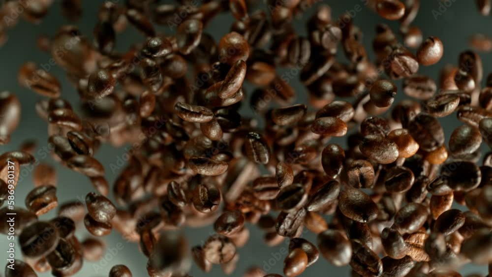 Poster Super slow motion of rotating coffee beans on black background. Filmed on high speed cinema camera, 1000 fps placed on high speed cine bot.  Camera moving up with rotation. Speed ramp effect.