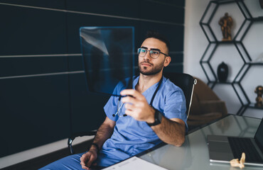Focused male doctor examining chest x ray