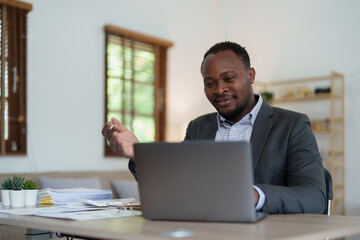 african american man, video call and laptop, wave hello and meeting, consulting or internet planning in startup company. Happy worker greeting for online meeting, computer webinar