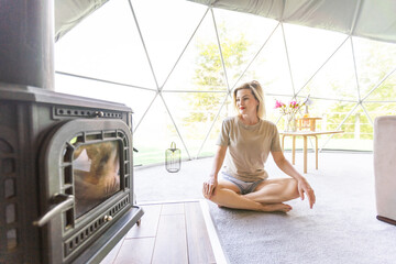 Pretty young caucasian woman resting in glamping outside city. Relaxation concept