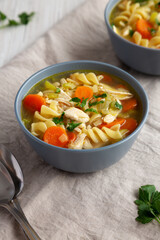 Homemade Chicken Noodle Soup in a Bowl, side view.