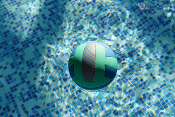 Photography of the swimming pool. Area to play in the water. Water polo ball is lying on the water surface. Sports theme. Healthy lifestyle concept.