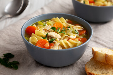 Homemade Chicken Noodle Soup in a Bowl, low angle view. Close-up.