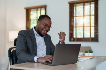 Fototapeta premium middle aged man American African business man holding computer laptop with hands up in winner is gesture, Happy to be successful celebrating achievement success