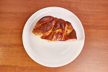 Delicious pie with cheese and cherry jam on a white plate.