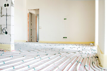 Installation of underfloor heating pipes for water heating. Heating systems. Pipes for underfloor...