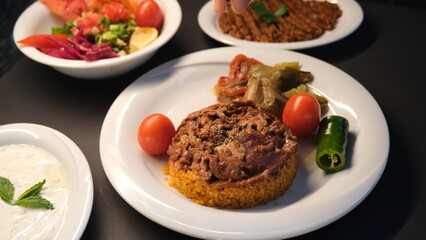 Stuffed lamb with appetizers on the presentation plate