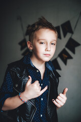portrait of a boy with a smile
boy in a leather jacket, grunge style, black style, rock, black nails