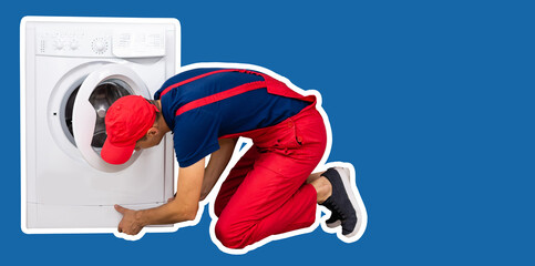 The repairman in worker suit with the professional tools box is fixing the washing machine on a blue background