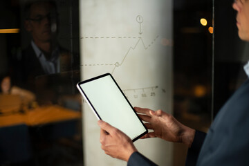 Close up of man using digital tablet.