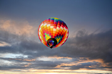 Colorful hot air balloon flying at sunset