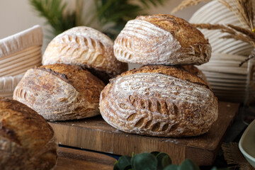 Artisan Batard Sourdough healthy Bread with leaf scoring. Open crumb high hydration Sourdough bread set on white table. - 586946360