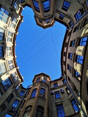 View from below on the blue sky, the courtyard-well of the original form, located in the center of St. Petersburg.	