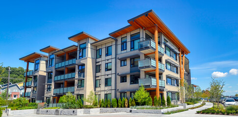 Brand new apartment building on sunny day in British Columbia, Canada - obrazy, fototapety, plakaty