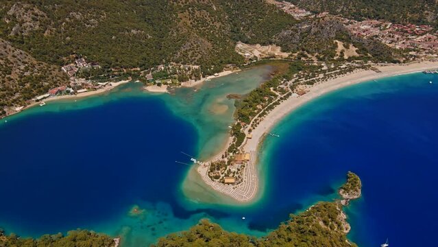 Oludeniz is a resort village on the southwest coast of Turkey. known for the blue lagoon of Oludeniz Tabiat Parki and the wide, white Belcekiz Beach.