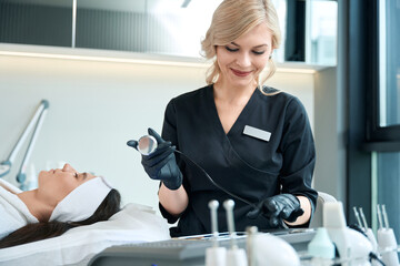Doctor preparing for skin rejuvenation therapy, working in salon