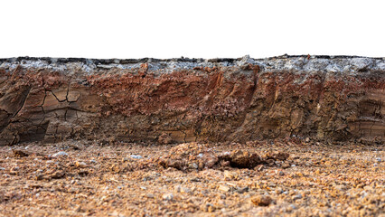 A cross-sectional view of the layer of soil beneath the paved road that was excavated and covered with dirt and dust to prepare for the construction and renovation of one of the Thai rural highways.